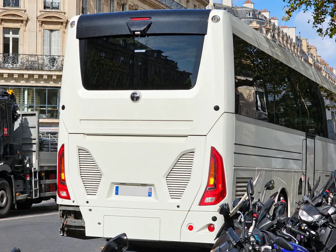 BusCom coach on a Haussmann street in Paris