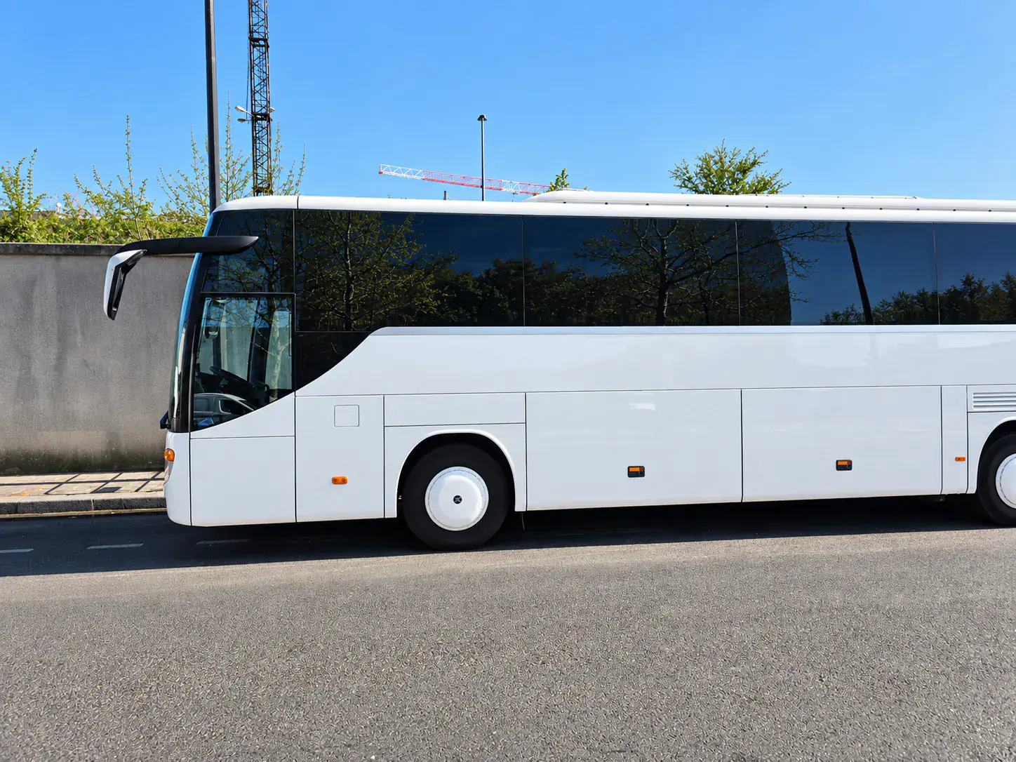 White BusCom coach, side view, ready for a Beauvais airport transfer to Paris