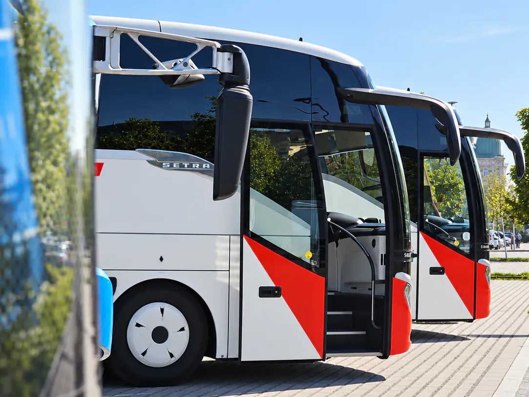 Row of BusCom Setra coaches with their doors open, for groups in Milan