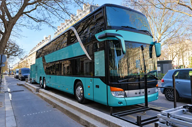BusCom double-decker coach on a Paris boulevard