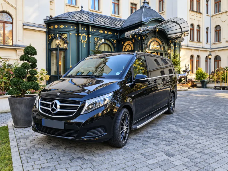 BusCom 7-seat Mercedes V-Class van at a hotel entrance