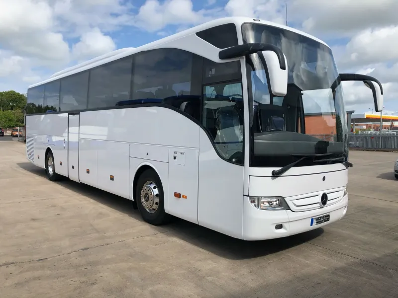 White Mercedes-Benz coach, ready for a group