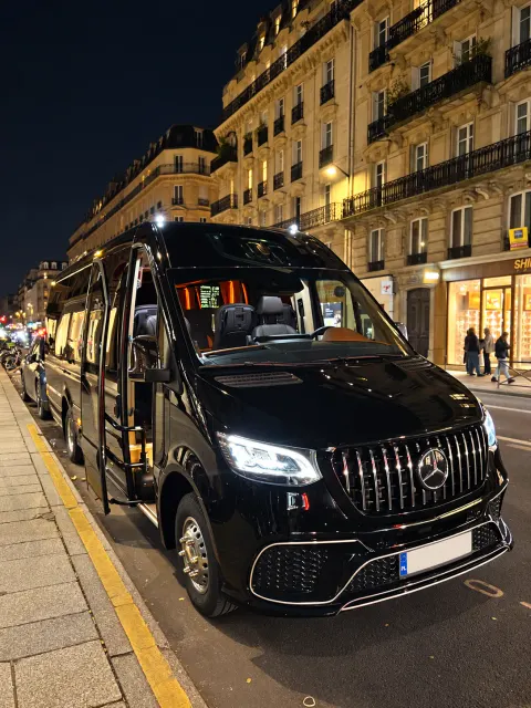 Black Mercedes Sprinter on a Paris street at night, door open